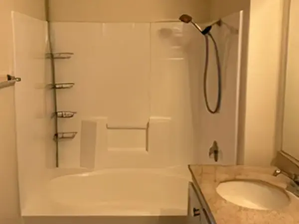A dated bathtub and shower combo