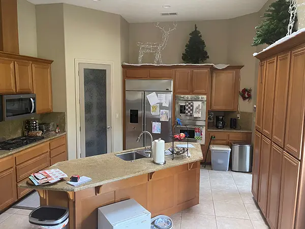 A dated kitchen with wood cabinets and Christmas decorations