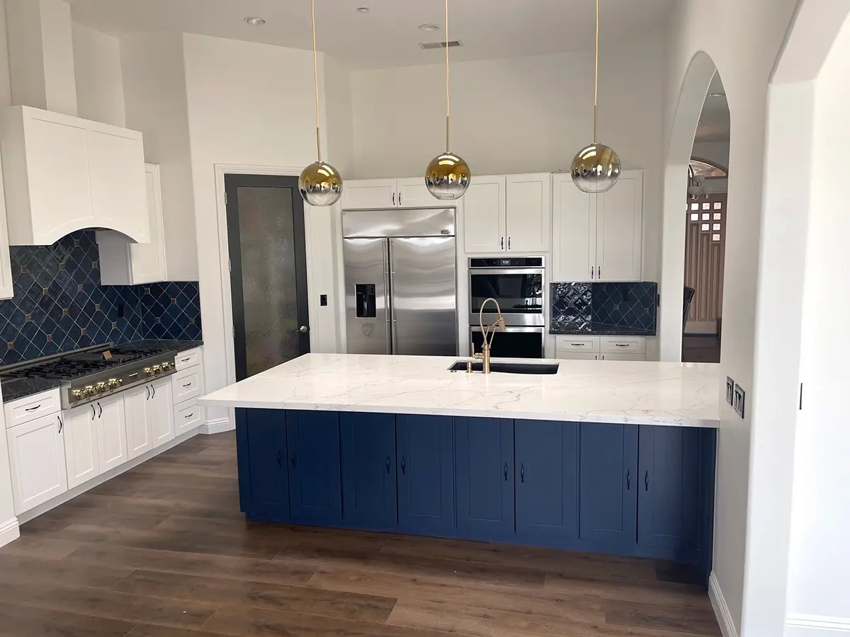 Engineered wood floor in a kitchen with navy blue and white cabinets