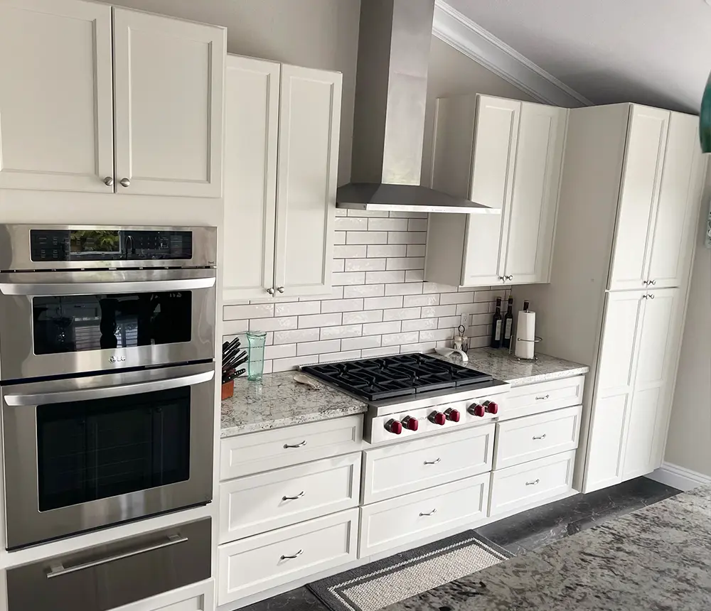 Beautiful white kitchen cabinets with quartz countertops and silver appliances